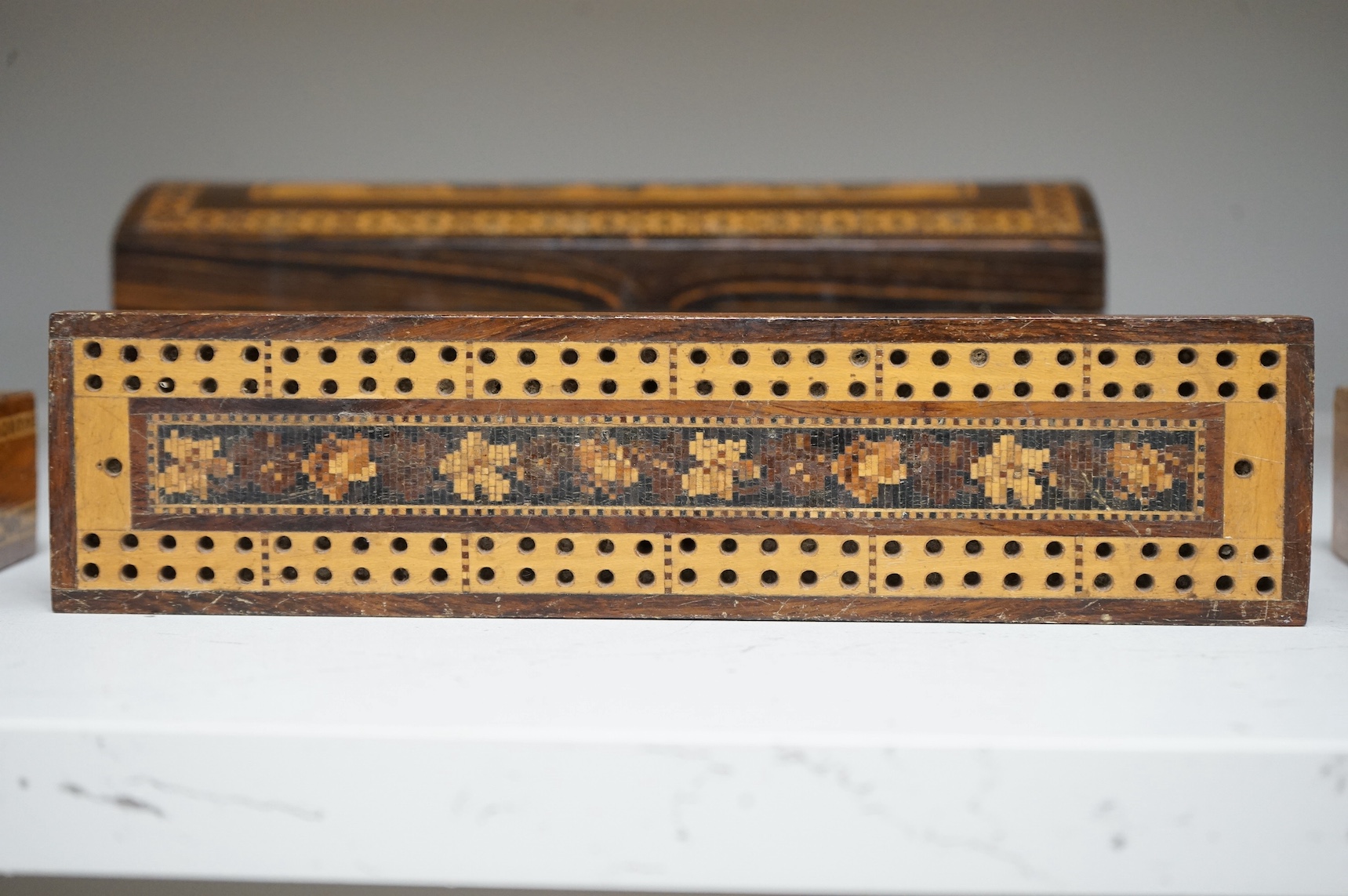Three Tunbridge Ware boxes to include a glove box, another housing a set of miniature playing cards and a cribbage board, 24cm. Condition - fair